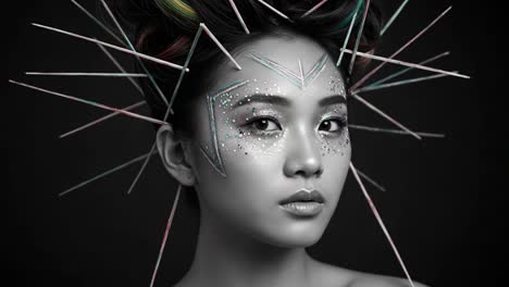 stunning close-up of a model with intricate spiked hair and artistic makeup, capturing uniqueness and creative expression in a striking monochrome setting