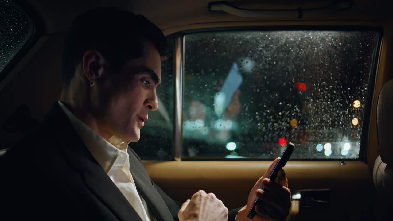 Happy entrepreneur rejoicing smartphone in vehicle closeup. Manager celebrating