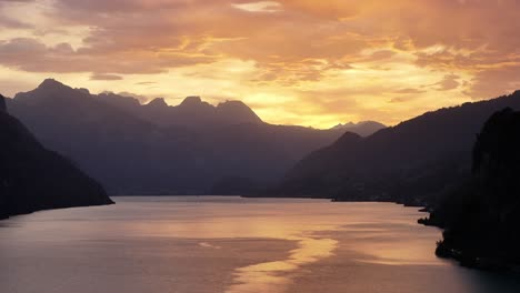 vibrant sunset over walensee, switzerland, with soft light reflecting on the calm lake surface