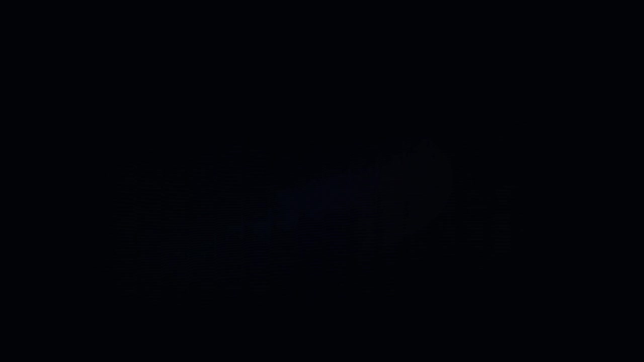 Abstract Light Flare Moving Across Dark Background