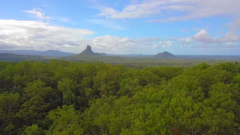 Aerial-view-of-a-tropical-forest-valley---mount-Coonowrin-and-Ngungun-at-daytime