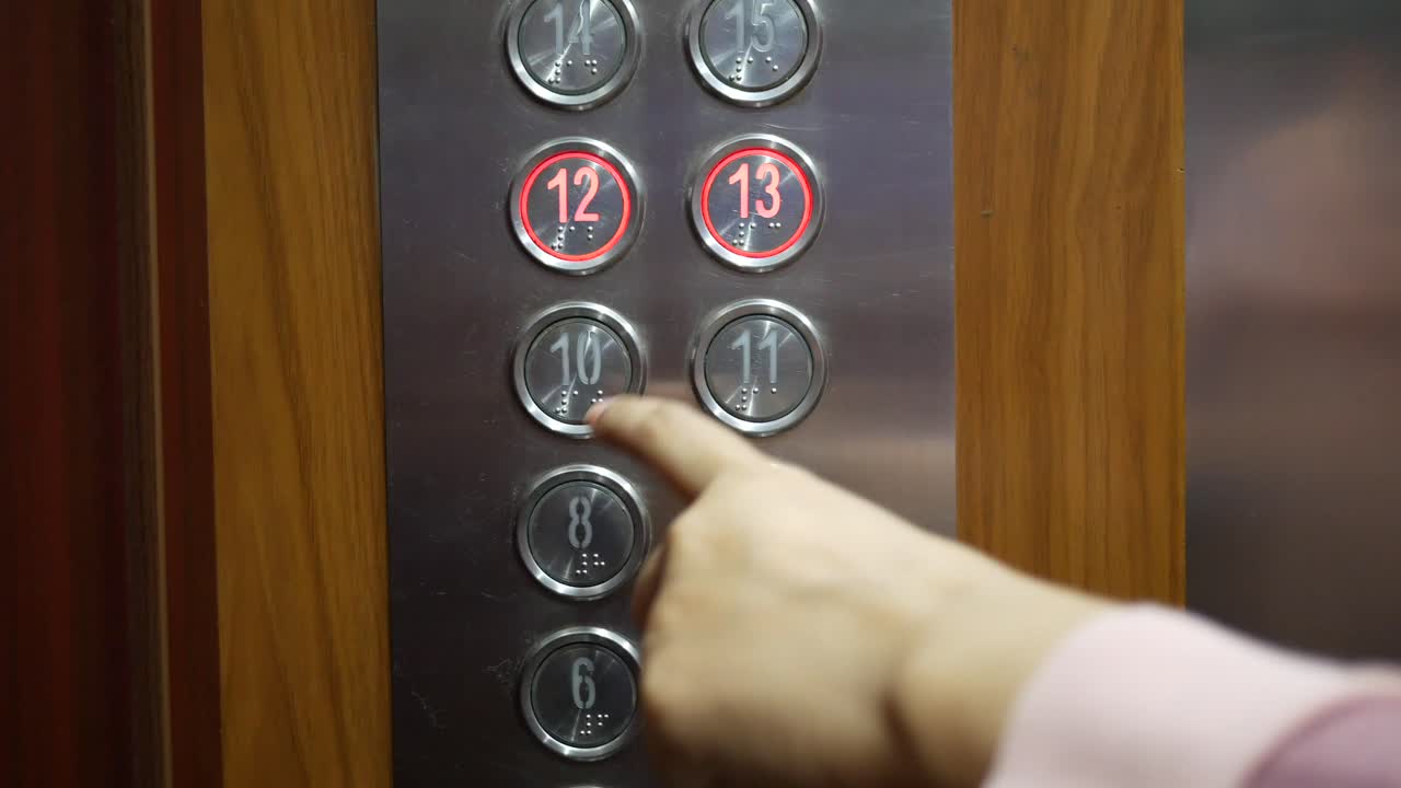 Person Pressing Elevator Buttons