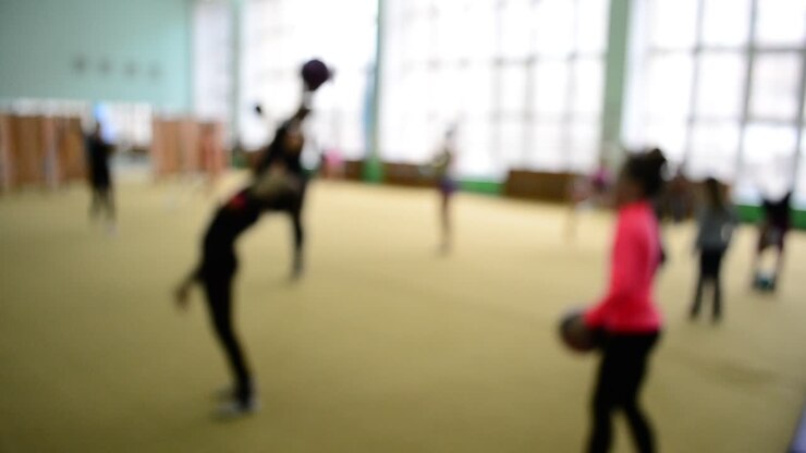 Warm-up of gymnasts before performance. Out of focus. Warm-up of gymnasts before performance