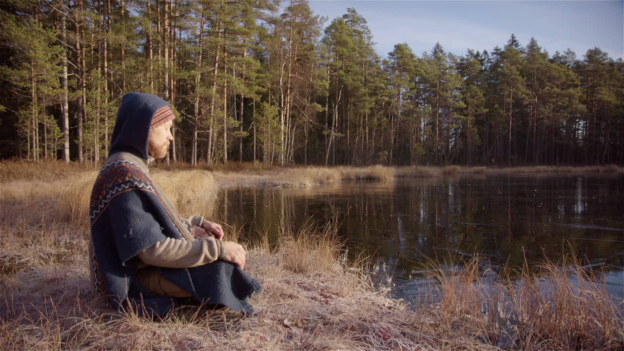estática ancha: un hombre guapo se sienta en una pose fácil meditando antes de un baño de hielo