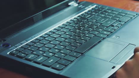 man opening laptop and starts typing on keyboard of computer 01