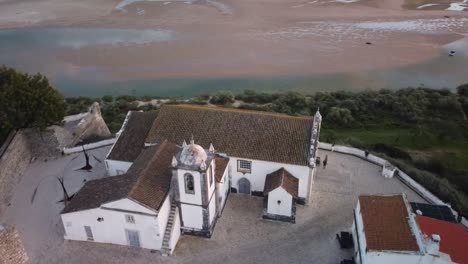 aerial circle pan, orbit, over the beautiful cacela velha church