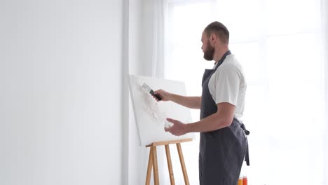 a professional artist paints a picture