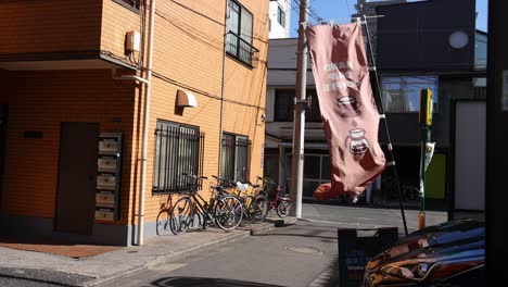 flag waving in the wind against building backdrop