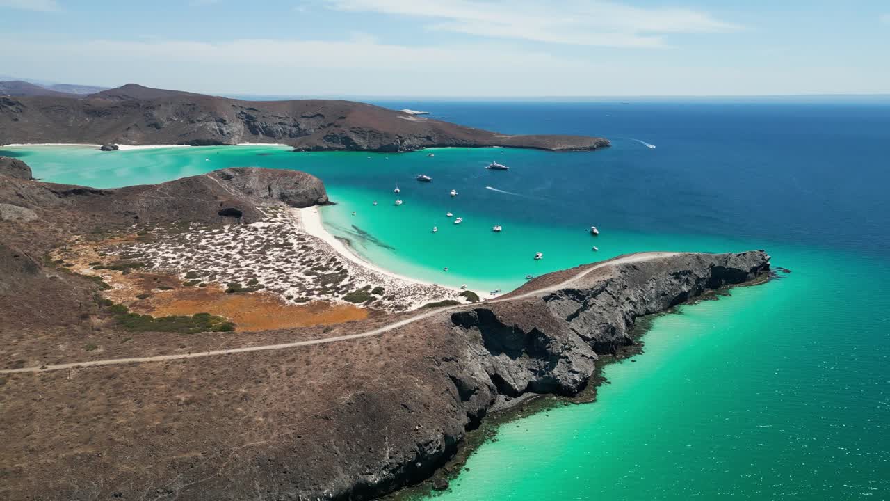 Breathtaking aerial shot of turquoise waters, sandy beaches, and rocky coastlines near La Paz, Tecolandra