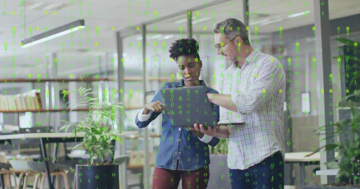 Developer presenting laptop to coworker, binary overlay streaming, tapping card for encryption demo