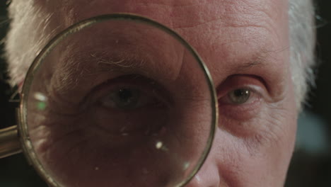 an older man looks through the loupe
