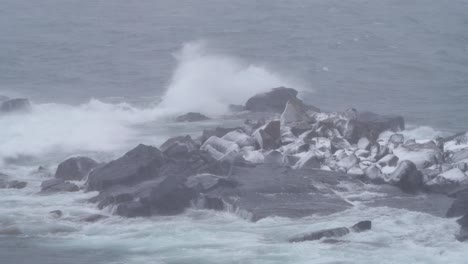 rough waves crashing on the rocks in winter. - wide shot