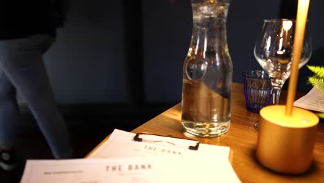 a table setting with a candle and menu