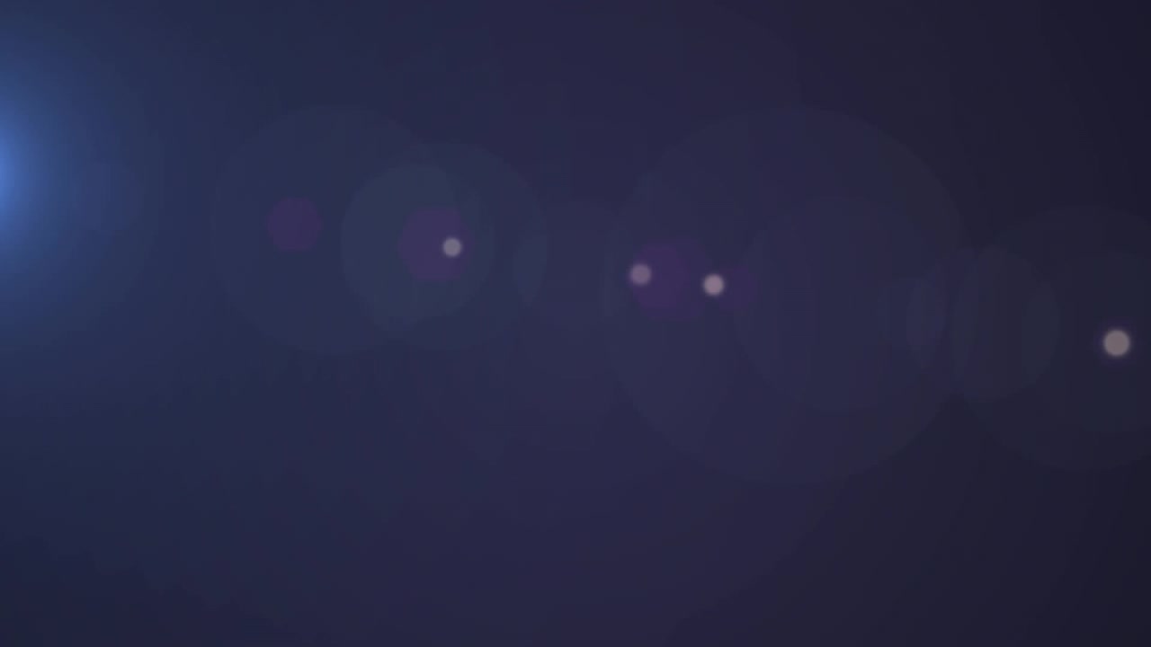 Animation of beam of light and bokeh spots of white light on dark background