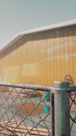 rusty chain link fence in front of an industrial building