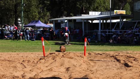 motorcyclist jumps over dirt mound