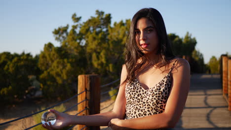 a beautiful woman looking serious with a magical crystal ball staring into the camera with intense eyes