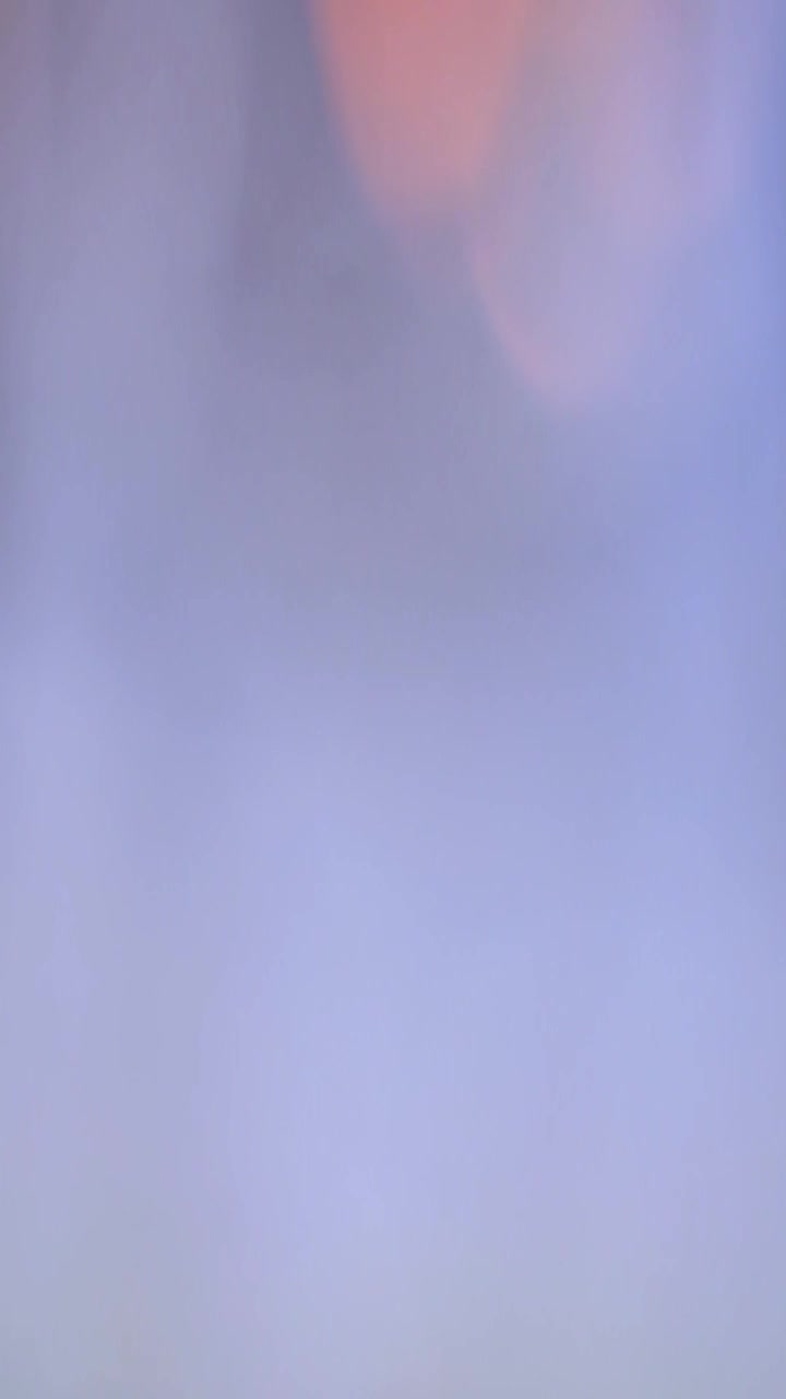 Abstract Background of Soft Glowing Orange and Purple Light Bokeh
