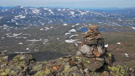 pile of stones at the snowy landscape at helagsfjallet in sweden. wide shot