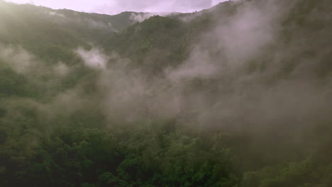Aerial-view-flying-above-lush-green-tropical-rain-forest-mountain-with-rain-cloud-cover-during-the-rainy-season-on-the-Doi-Phuka-Mountain-reserved-national-park-the-northern-Thailand