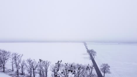 rural landscape bedecked with snow and shrouded in fog