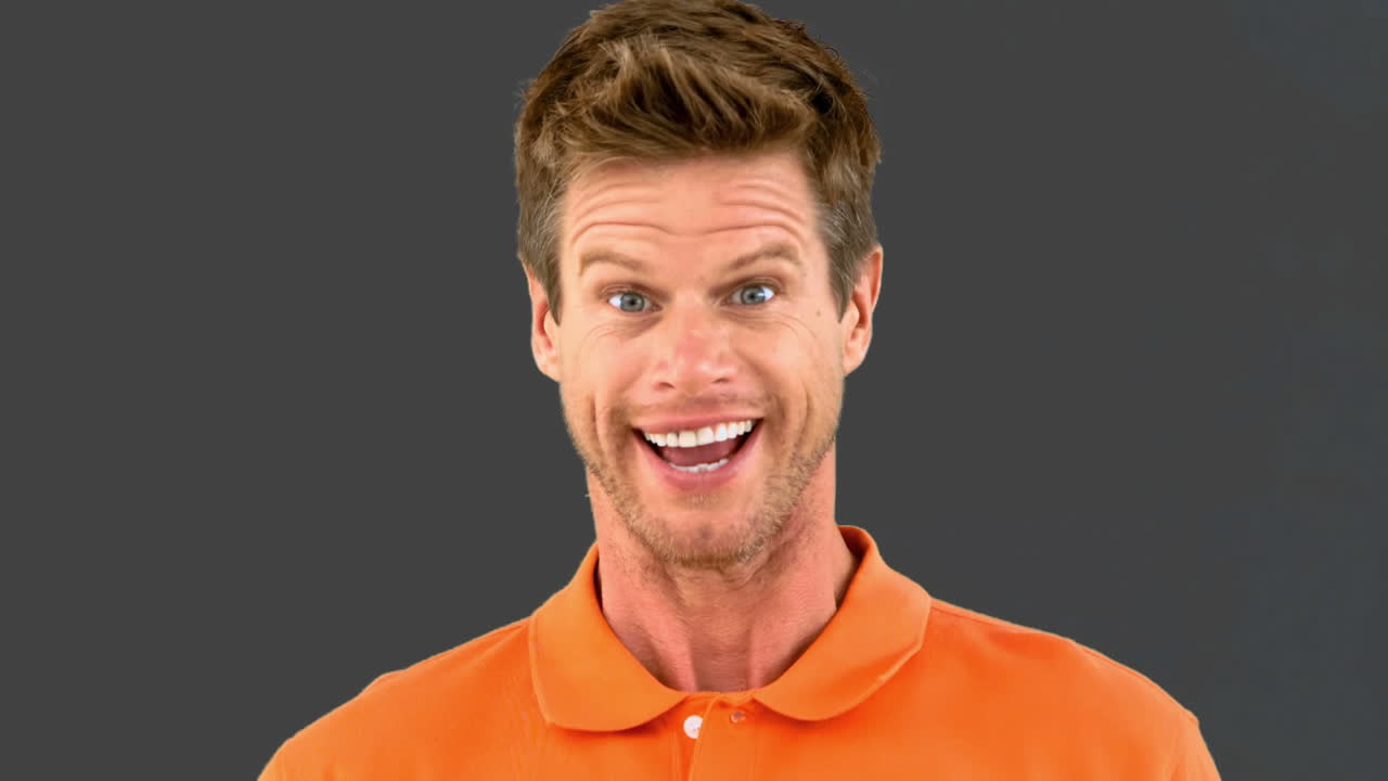 Handsome man saying yes with his head on grey screen