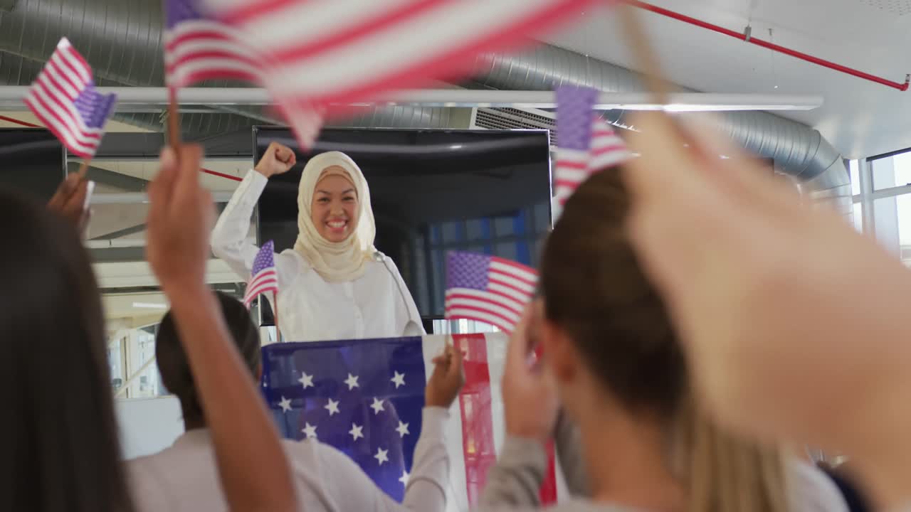 Victorious female speaker and audience at political convention