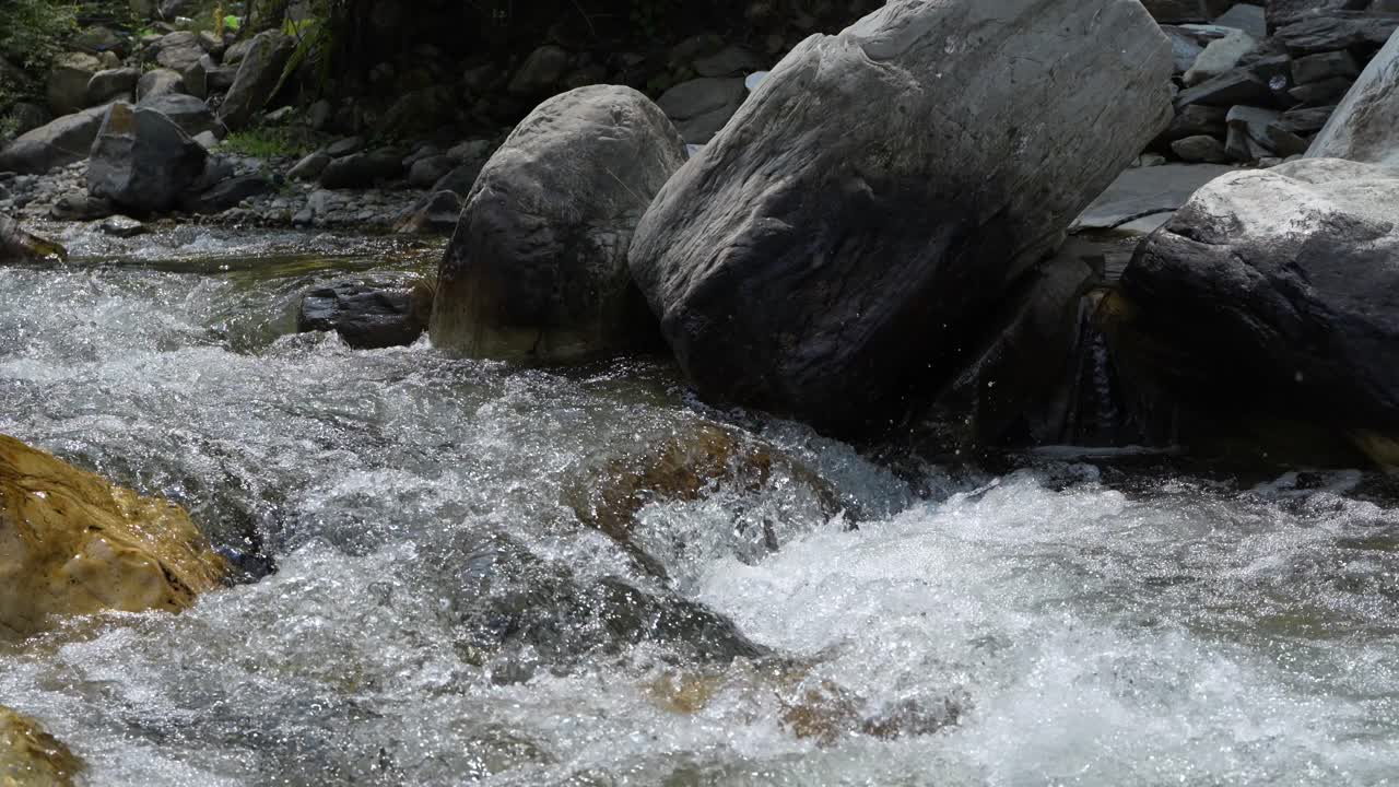 Water is flowing through a mountain torrential river.