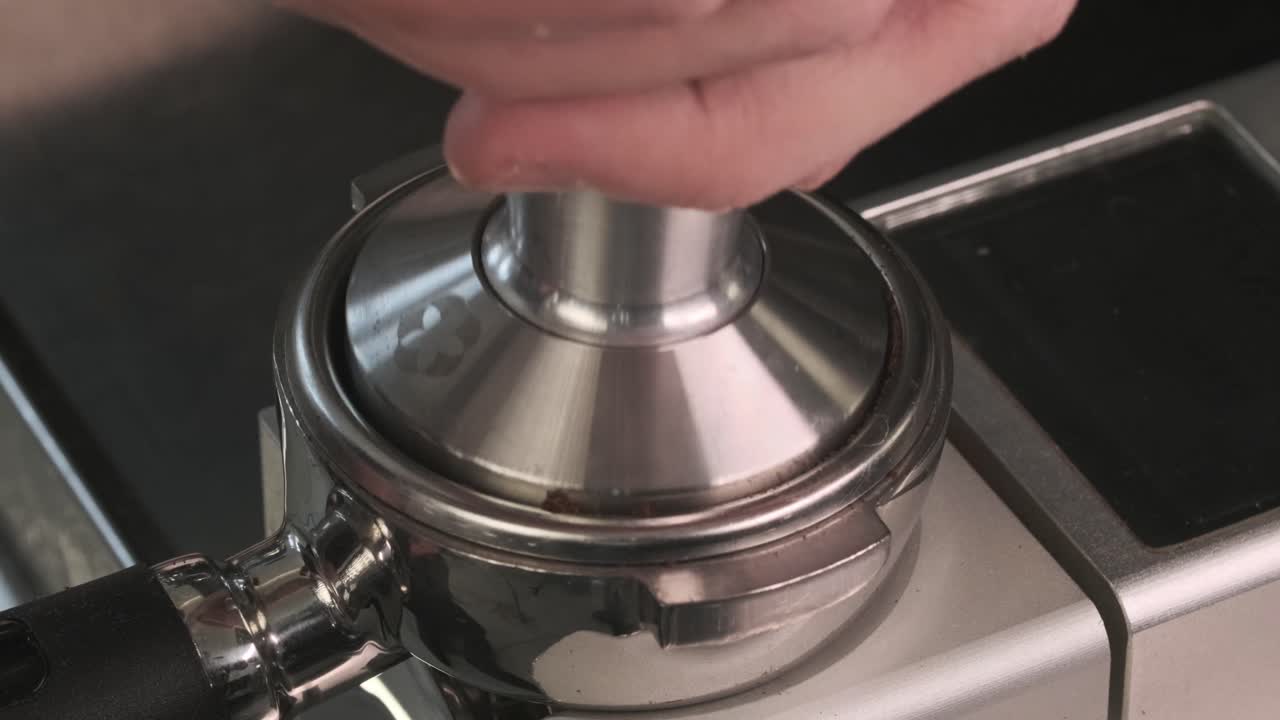 Close up of coffee powder being pressed and prepared for brewing a fresh cup of espresso