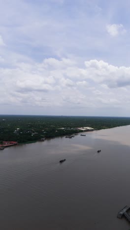 aerial view - vertical shot pan of two ships in the mekong river.