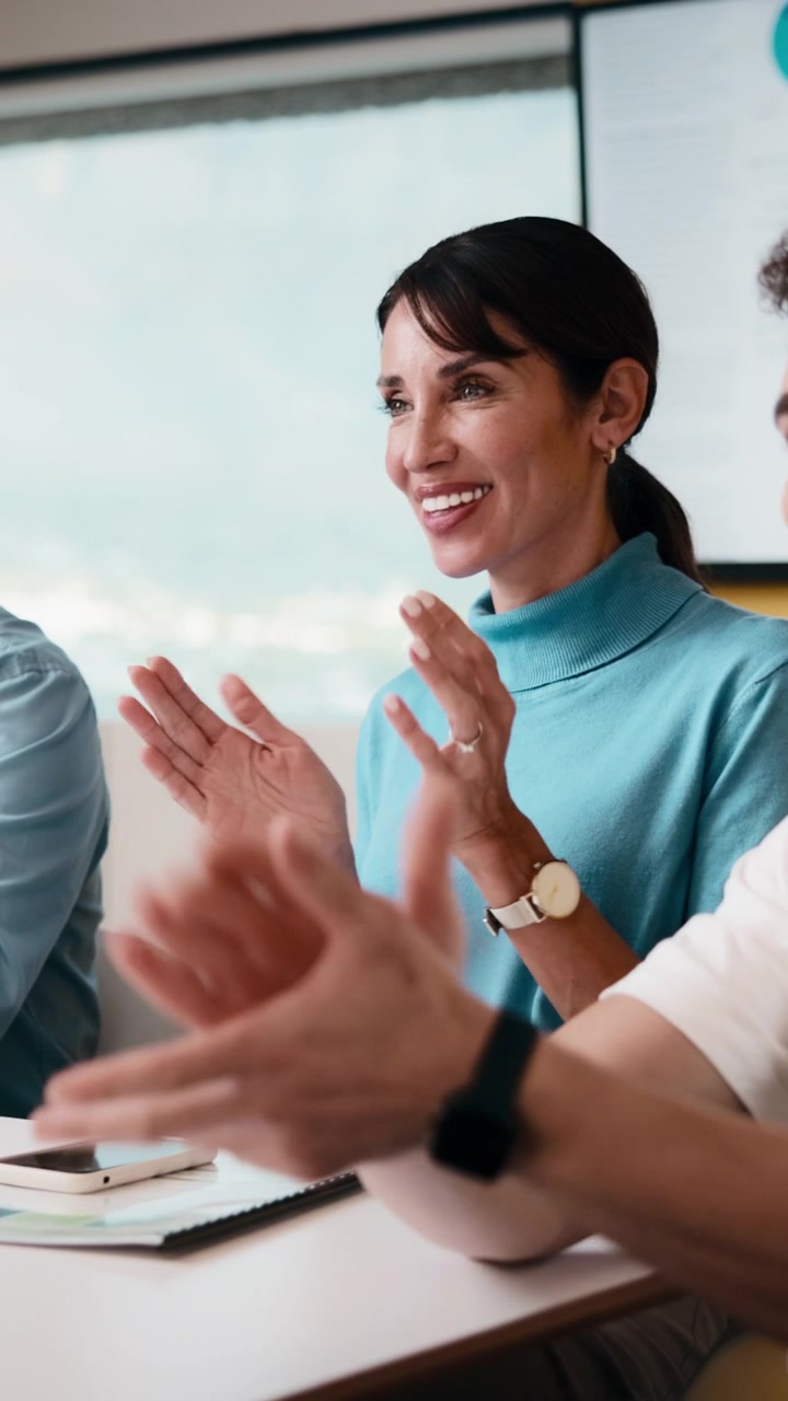 Professional Businesswoman Applauding During a Team Meeting