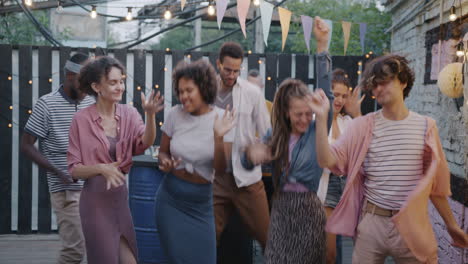 friends dancing at a backyard party