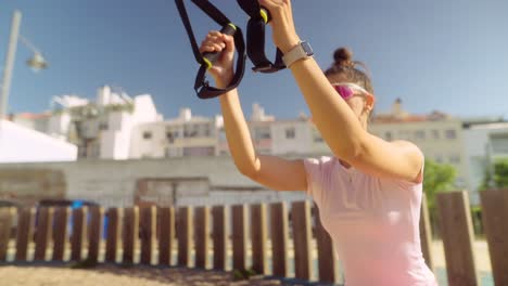 mujer haciendo entrenamiento de suspensión al aire libre
