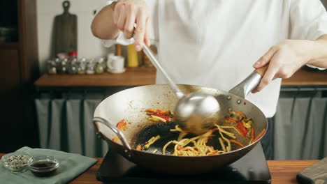 cooking noodles in a wok