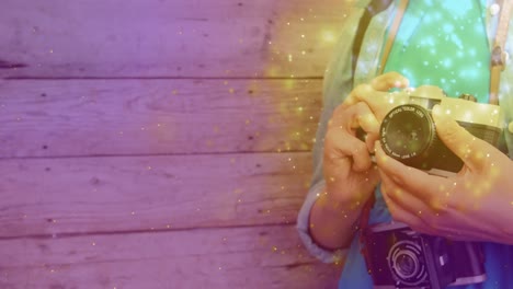 brillando contra la sección media de la fotógrafa que sostiene su cámara digital