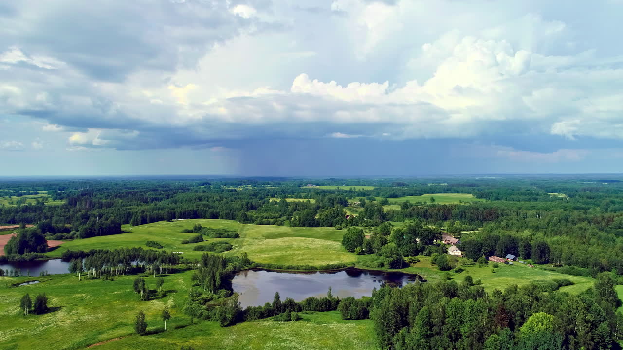 Bird's eye view of a mixed landscape, green meadows, forests and small lakes