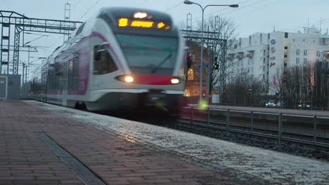 train arrives on empty station on cloudy day