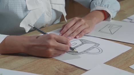 close up of woman designer sketching hand bag on the layout bond