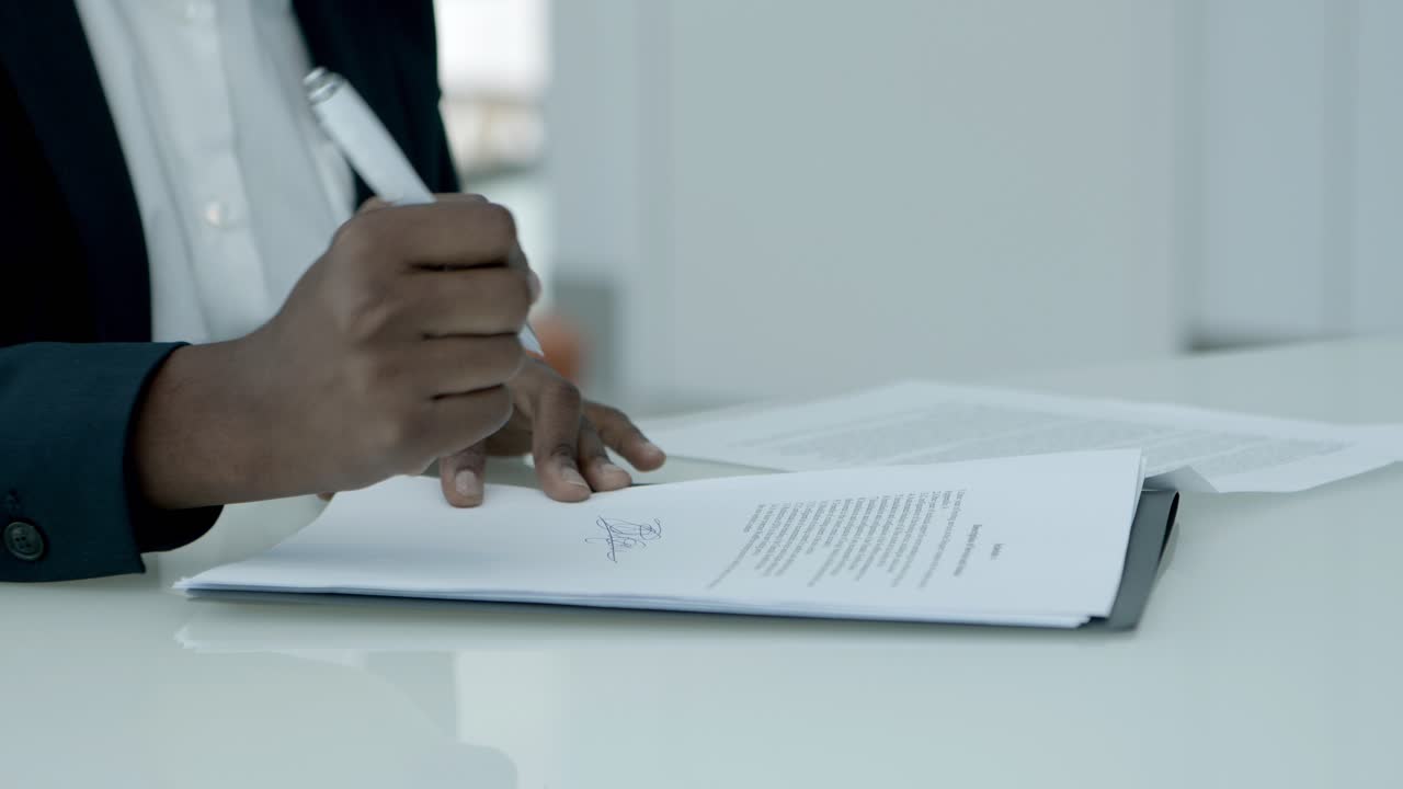 Businesswoman signing papers