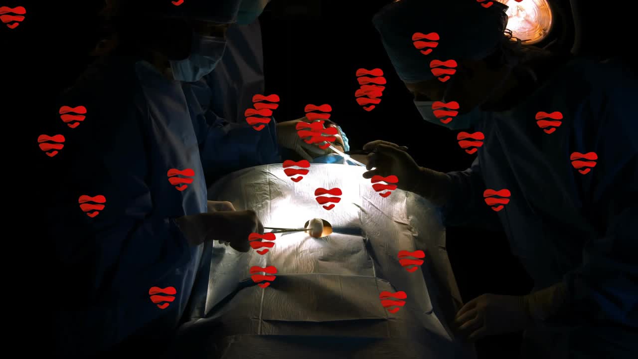 Tray opening surgeon arranging and assistant adjusting lamp, hearts floating showing teamwork