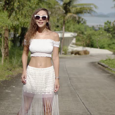 cheerful female walking on path in tropical country