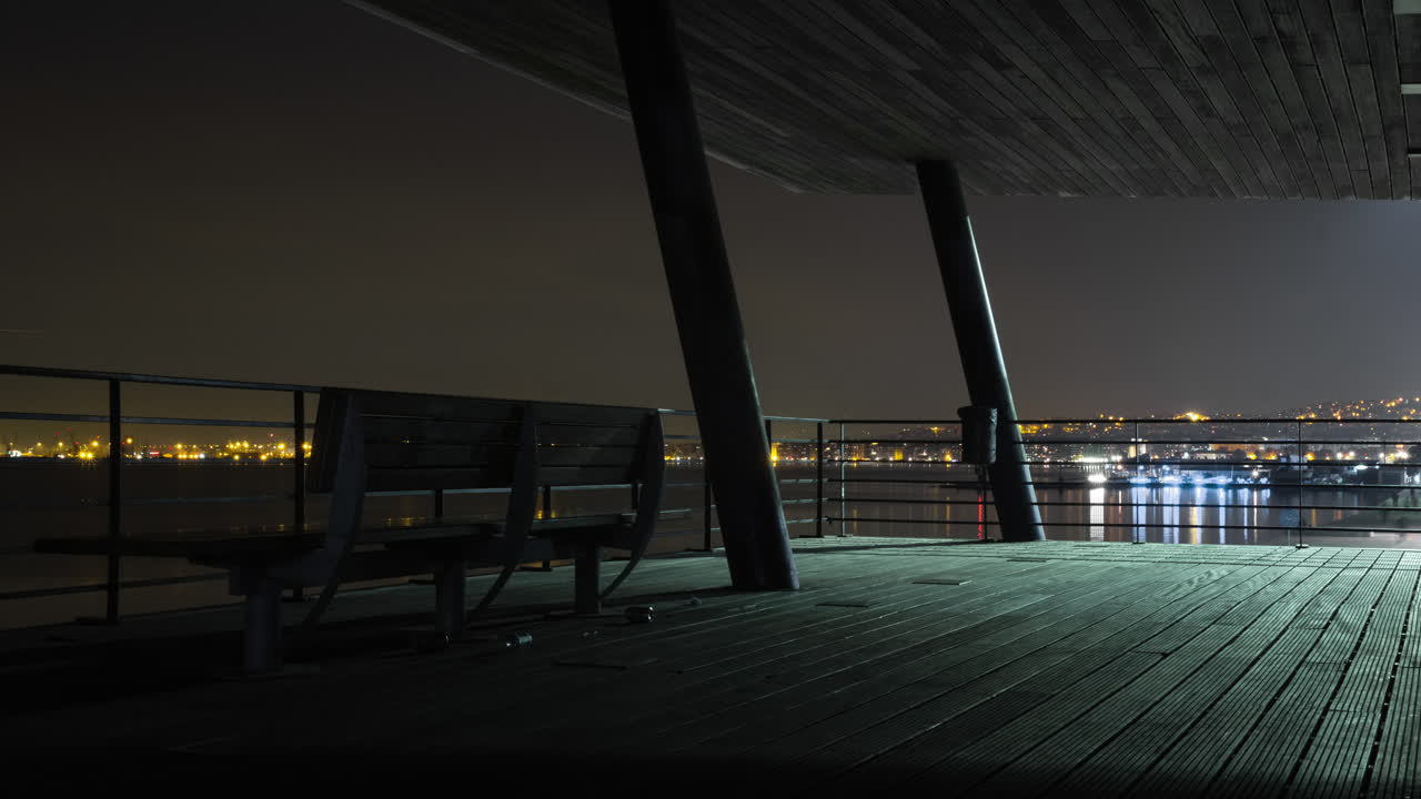 Night timelapse people relaxing bench Thessaloniki New Beach Promenade City lights backround