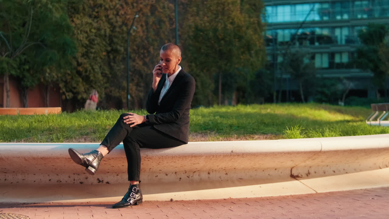 Happy Businesswoman Talking on Mobile Phone in Urban Park