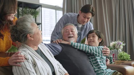 happiness asian multi generation family,grandparent grandchild hug kissing together with love tenderness care giving spent time together three generations people having fun together, sitting on couch