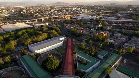 drone shot of freeways and historical lecumberri prison in mexico city during sunset