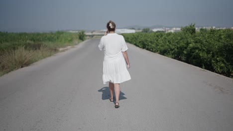 mujer caminando por un camino de campo