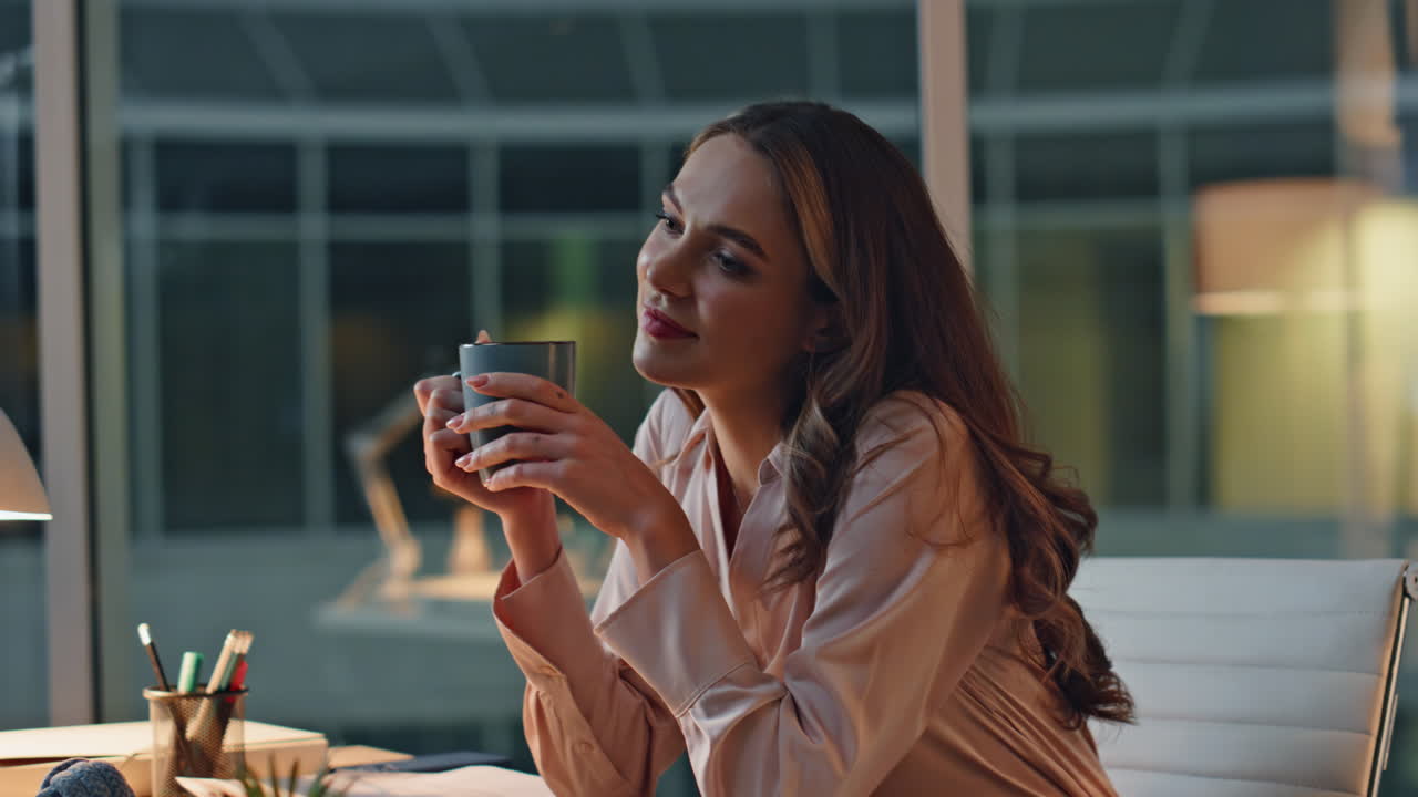 Professional woman taking break in night office. Closeup woman drinking coffee