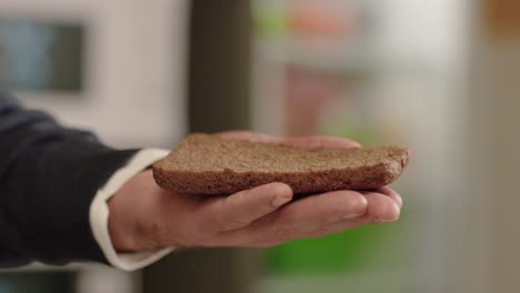 hand holding a slice of bread