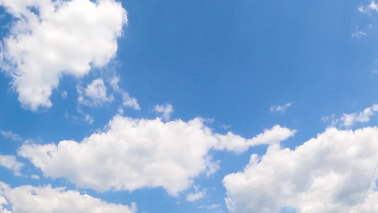 White soft clouds transforming into grey ones. Summer sky with cloudscape from low angle view. Timelapse.