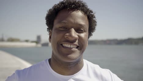 handsome young man smiling on camera.